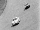 Chassis number 750061 (#27) leads an Autodelta Alfa Romeo Giulia Sprint GTA (#56) through the high bank at Monza in the 1965 1000 KM of Monza.