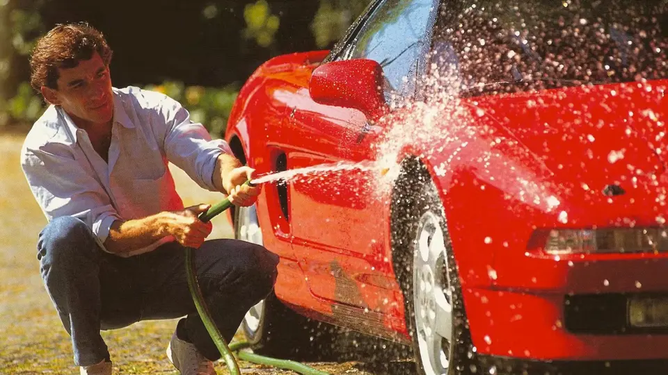 Ayrton Senna is pictured washing the NSX in a timeless shot.
