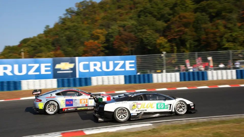 The Team JLOC Murciélago R-GT GT1 passes the Team Hong Kong Racing Aston Martin V8 Vantage GT2 in the Asian Le Mans Series race at Okayama.