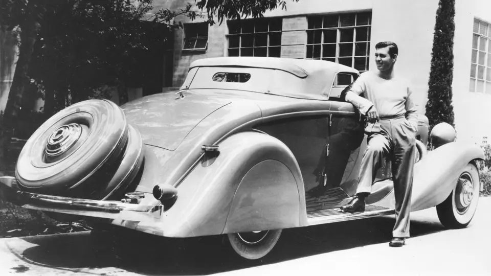 Legendary actor Clark Gable poses with his Duesenberg, his most prized automobile and part of the happiest years of his life.