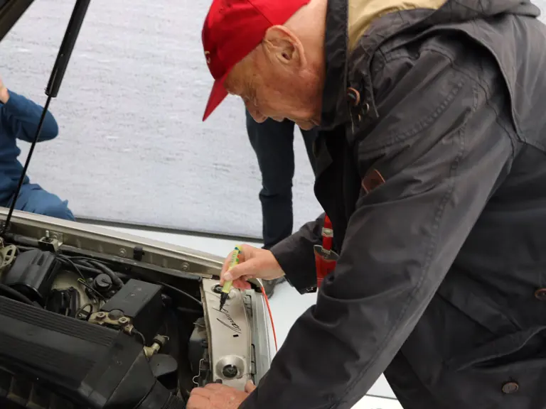 Niki Lauda is captured signing the engine bay of the 190 E 2.3-16 at the 2016 Australian Grand Prix.