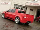 Ford Sport Trac Adrenalin teaser: Wide fender blisters and an integrated rear spoiler give the Adrenalin an impressive rear view.