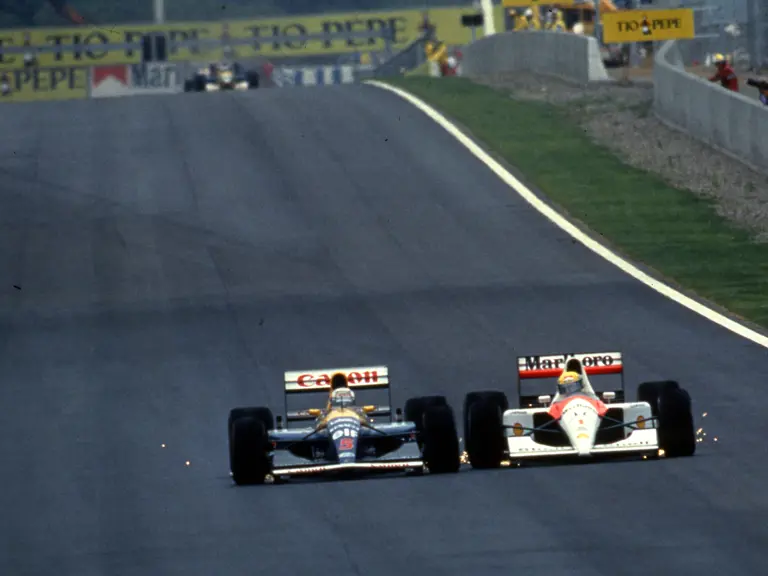 Nigel Mansell in his Williams FW14 battles wheel to wheel with Ayrton Senna in his McLaren MP4/6 to lead the 1991 Spanish Grand Prix.