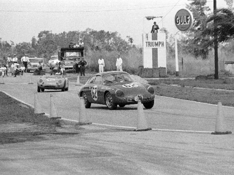 Chassis number 0200 (#62) leads a Porsche 718 RSK (#45) through a turn at the 1962 12 Hours of Sebring.