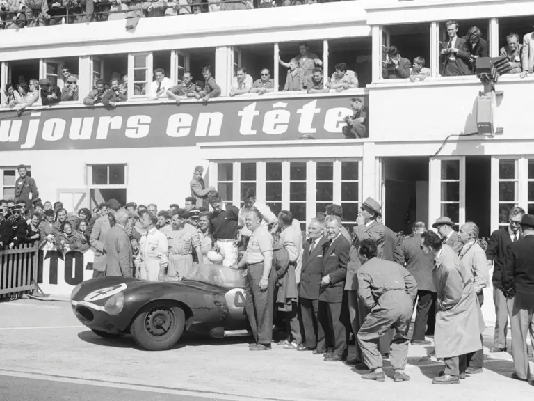 Chassis no. 501 poses with its drivers and other members of the Ecurie Ecosse team after winning the 1956 24 Hours of Le Mans.
