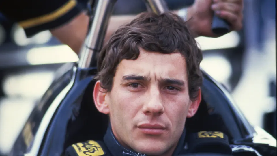 Ayrton Senna contemplates the race ahead at the 1986 San Marino Grand Prix.