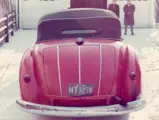 The Alfa Romeo wears its hood up to shield against the Chicago snow in the 1960s.