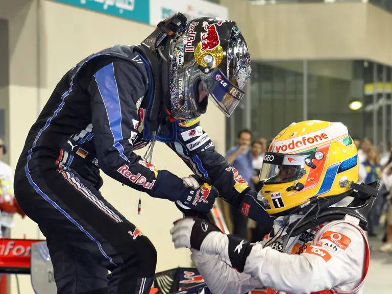 Lewis Hamilton congratulates Sebastian Vettel upon winning his first Formula 1 Drivers' Championship at the 2010 Abu Dhabi Grand Prix.