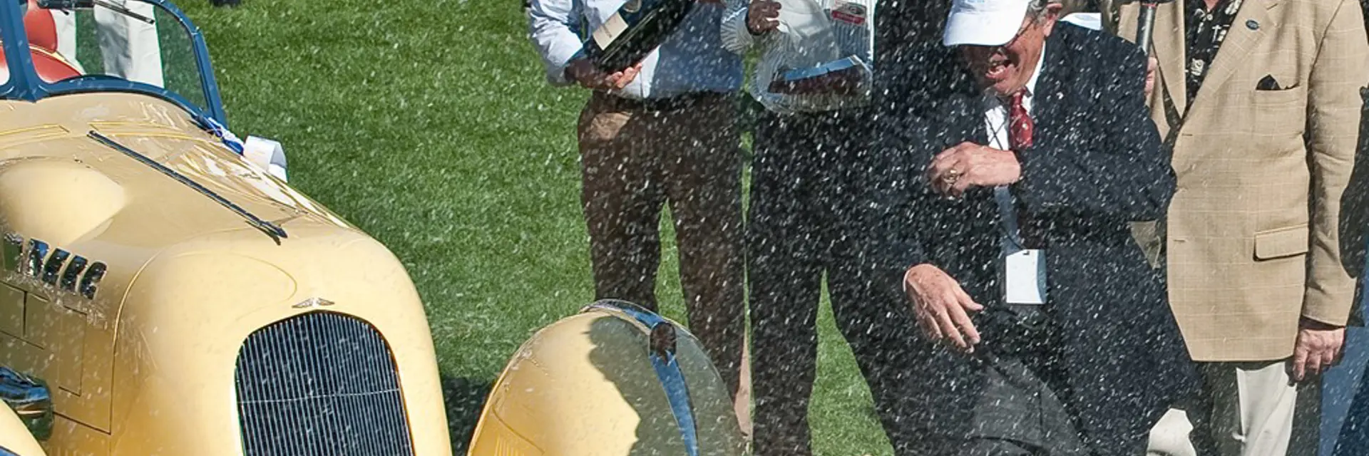 Amelia Island Concours dElegance founder Bill Warner being sprayed with champagne