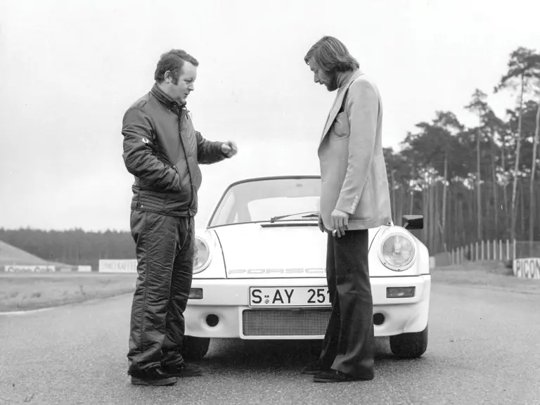 Jürgen Barth (right) and a journalist from Autosport discuss the performance of this Carrera RS during the press release, Hockenheimring, 1973.