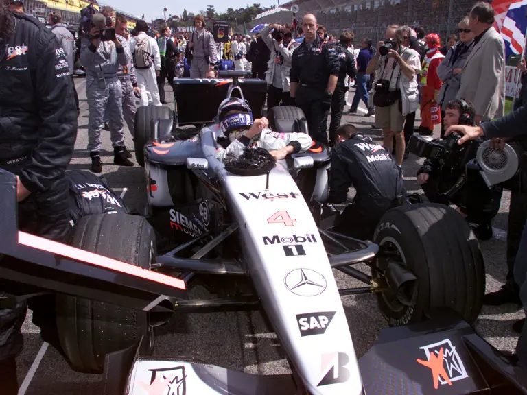 David Coulthard lowers himself into chassis MP4-16A-05 at the 2001 San Marino Grand Prix, where he would finish 2nd.