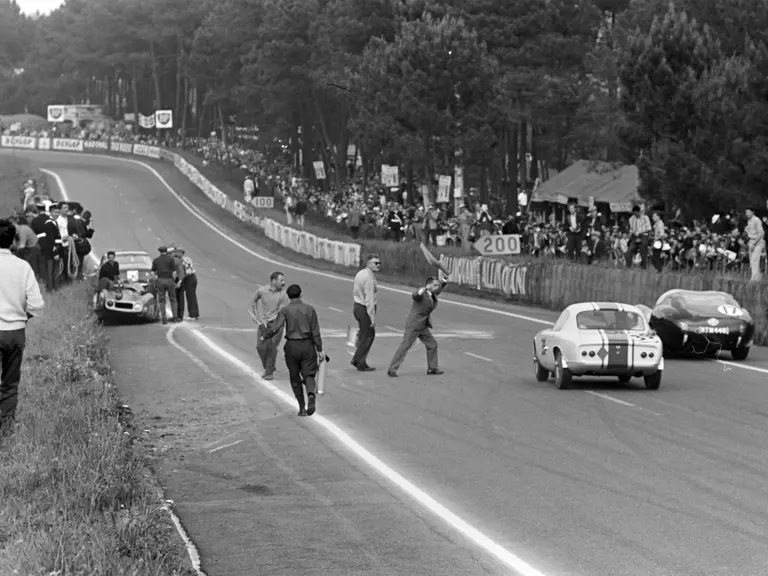 Pictured on the far left, the safety car responds to an incident on the circuit.