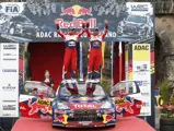 Sébastien Loeb and co-driver Daniel Elena stand atop the Citroën after winning the 2012 Rallye Deutschland.