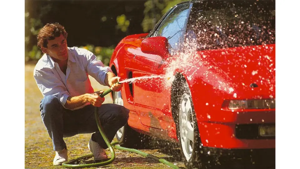 Ayrton Senna is pictured washing the NSX in a timeless shot.