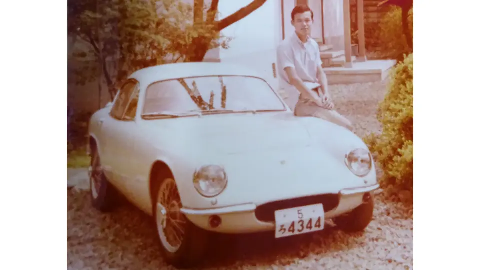 Hirotoshi Honda is pictured with the Lotus after its first rebuild, refinished in white.