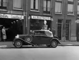 This Bugatti Type 49 Drophead Coupé stops for fuel at the Albatros Garage in Ramshorst, Holland.