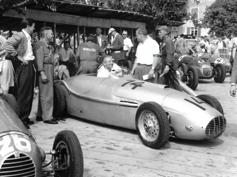 Toni Ulmen chats in the pit lane just before the start of the 1951 Swiss Grand Prix in Erlen, Switzerland.
