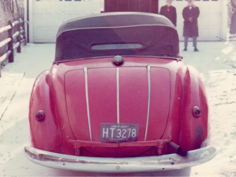 The Alfa Romeo wears its hood up to shield against the Chicago snow in the 1960s.