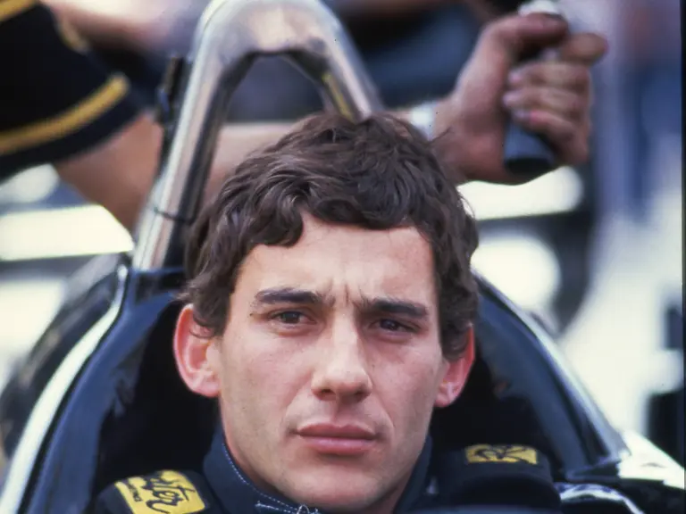 Ayrton Senna contemplates the race ahead at the 1986 San Marino Grand Prix.