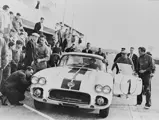 Dick Thompson (behind the wheel), Briggs Cunningham (side of door), and Alfred Momo (behind door) at the 24 Hours of Le Mans test day, April 1960.