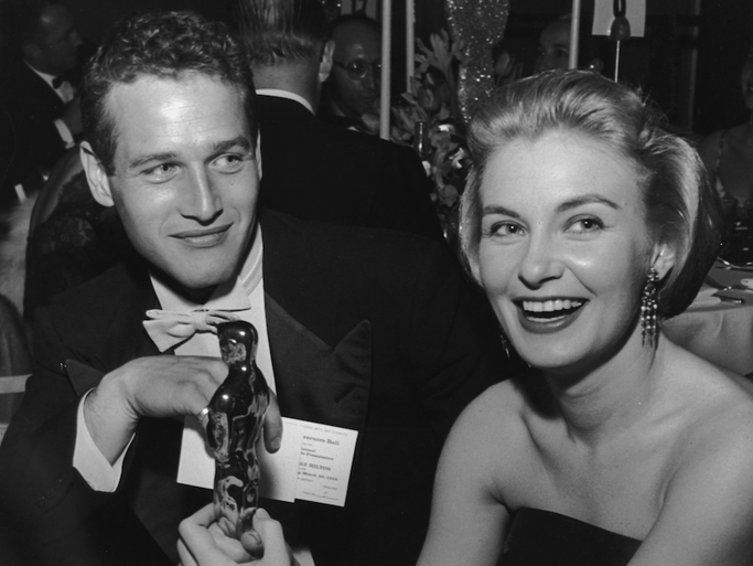 American actor Joanne Woodward holds her Oscar statuette while sitting next to husband, American actor Paul Newman