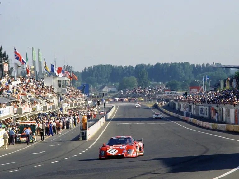 The Ferrari 512 BB/LM of Scuderia Bellancauto races past the pit lanes at the 1984 24 Hours of Le Mans.