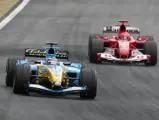 Fernando Alonso leads Michael Schumacher driving his Ferrari F2004 in Interlagos, Sao Paulo, Brazil at the 2004 Formula 1 Brazilian Grand Prix.