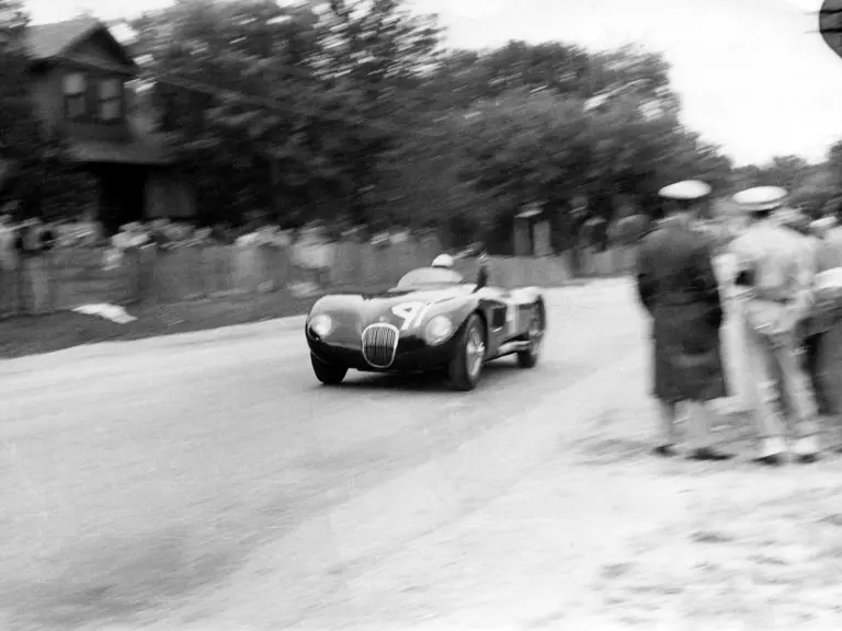 Phil Hill and XKC 007 race towards the very first victory for the C-Type in America at Elkhart Lake.