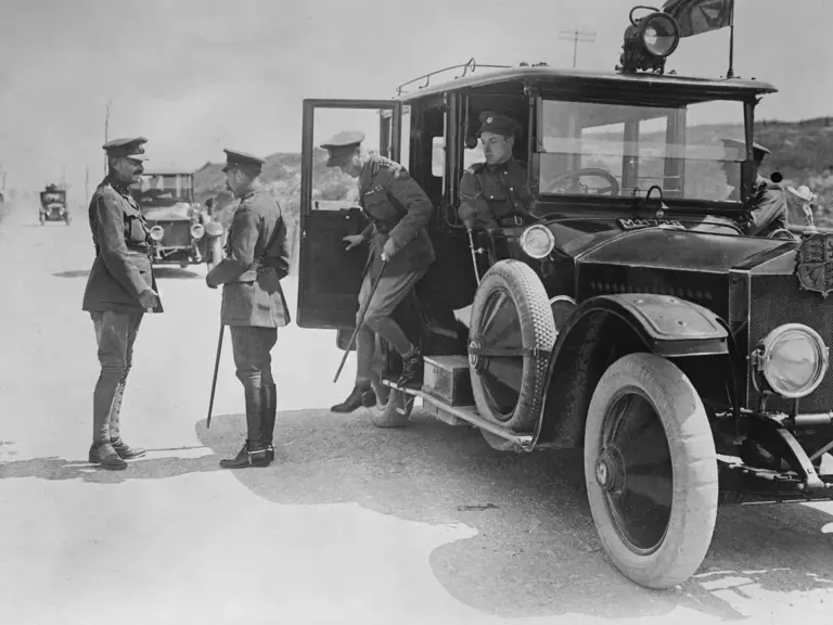 King George V and Edward VIII, Prince of Wales, are seen exiting the Rolls-Royce as they are greeted by General Julian Byng on arrival at Butte de Warlencourt near Le Sars, France, during World War I.