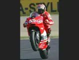 Loris Capirossi does a wheelie as he approaches the finish line during the 2006 Grand Prix of Japan.