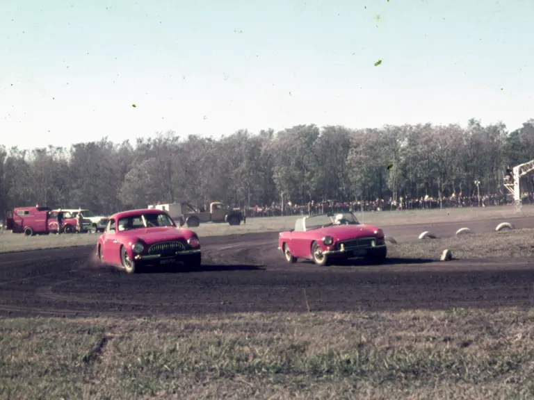 The Cisitalia takes the outside line against the more modern MG MGB on a dirt track in the early 1970s.