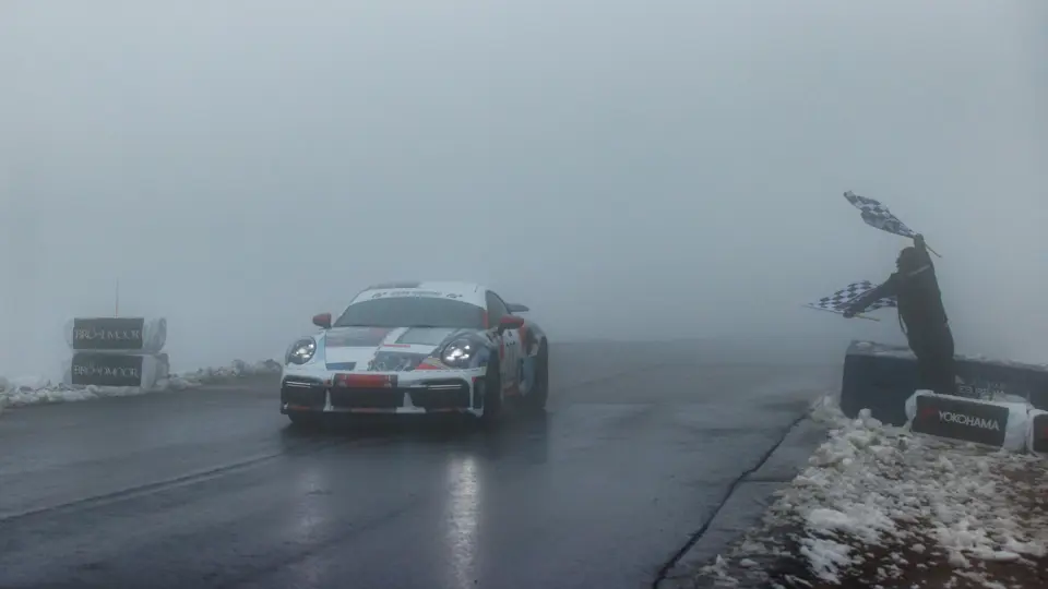 David Donner crossing the finish line behind the wheel of the Porsche 911 Turbo S Lightweight at the 100th running of the Pikes Peak International Hill Climb, June 2022.