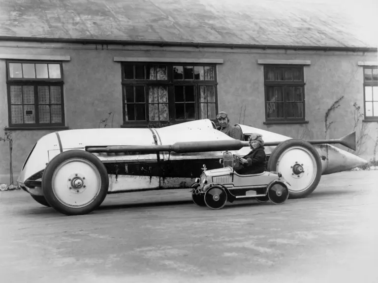 Captured after the Brooklands April race meeting, Parry-Thomas poses in the Leyland-Thomas Special next to Miss Anne Duke Williams.