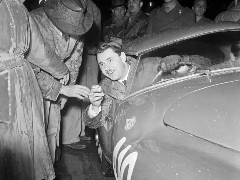 Gianni Marzotto interacts with the crowd at the start prior to the 1951 Mille Miglia.