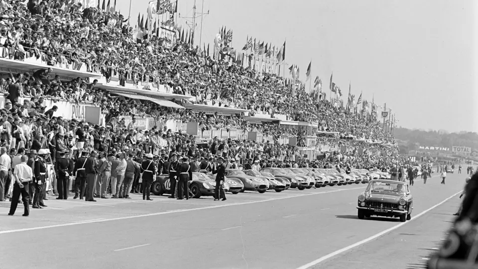 The Ferrari is captured driving along the grid prior to the start of the 1963 24 Hours of Le Mans.