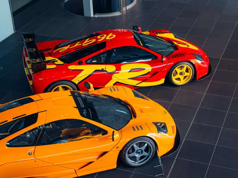 The 1990s pop art-inspired McLaren livery in scarlett red and yellow stands out next to a bright orange McLaren.