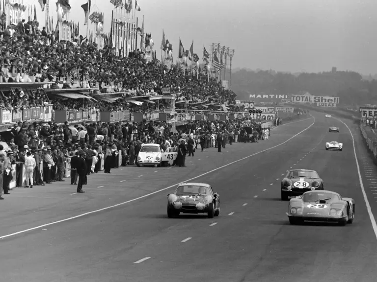Wearing race number 58, chassis 1725 powers past the pit lane crews at the 1967 24 Hours of Le Mans.