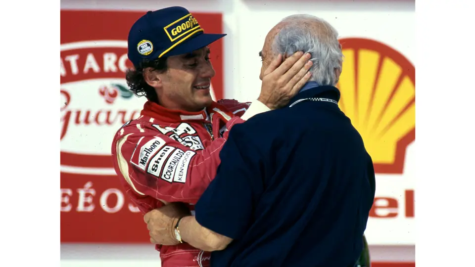 Juan Manuel Fangio embraces Ayrton Senna following his victory at the 1993 Brazilian Grand Prix. Fangio is wearing his treasured Omega Trésor watch on his left wrist.