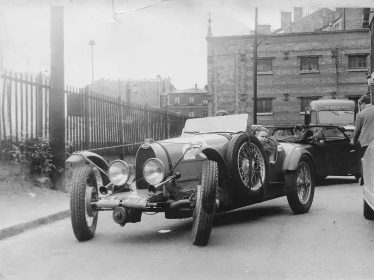 Bugatti enthusiast Francis Muel, who owned the car between 1956 and 1961, threads chassis 37363 down Rue Dantan in Saint-Cloud.