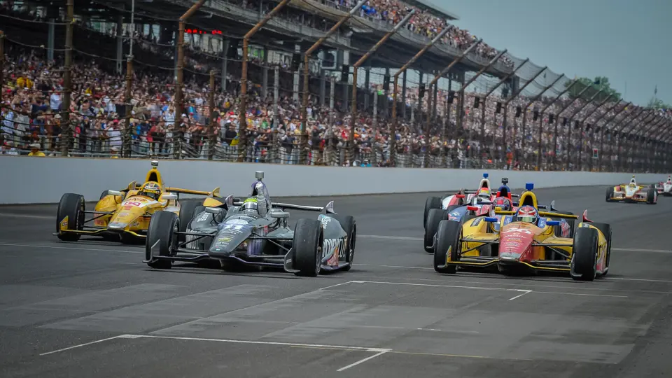 Tony Kanaan victoriously crosses the finish line at the 2013 Indianapolis 500.
