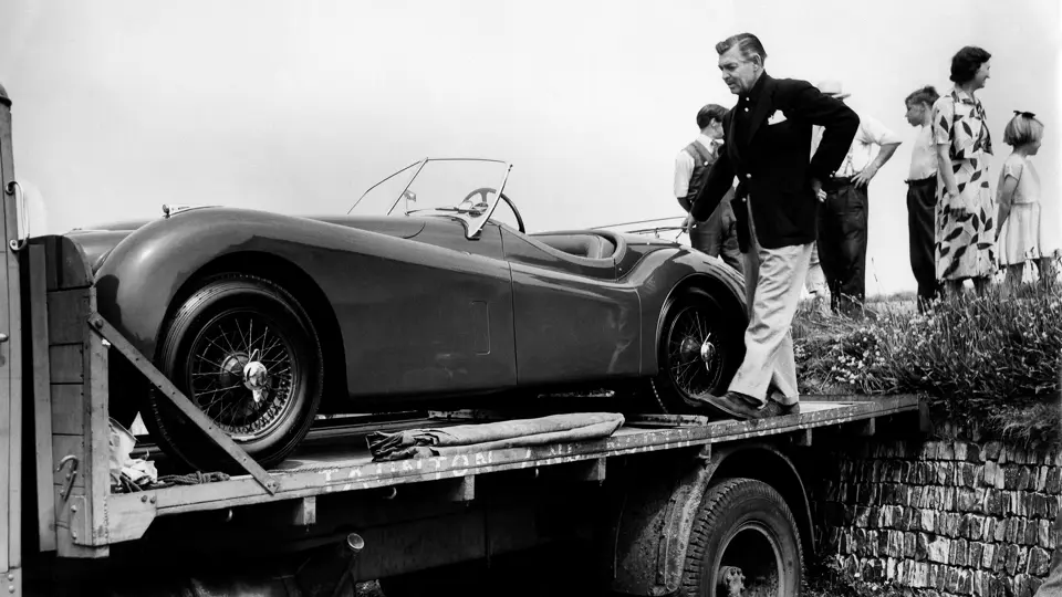 Clark Gable takes delivery of his brand new Jaguar XK 120 in 1953.