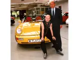 Walter Gnauert, former CFO of Porsche, stands with Flatz as the artist receives his car for the first time in 1994.