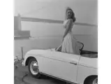 A beautiful woman poses in 82431 by the Golden Gate bridge prior to the Cobb Mountain Hill Climb, 1957.