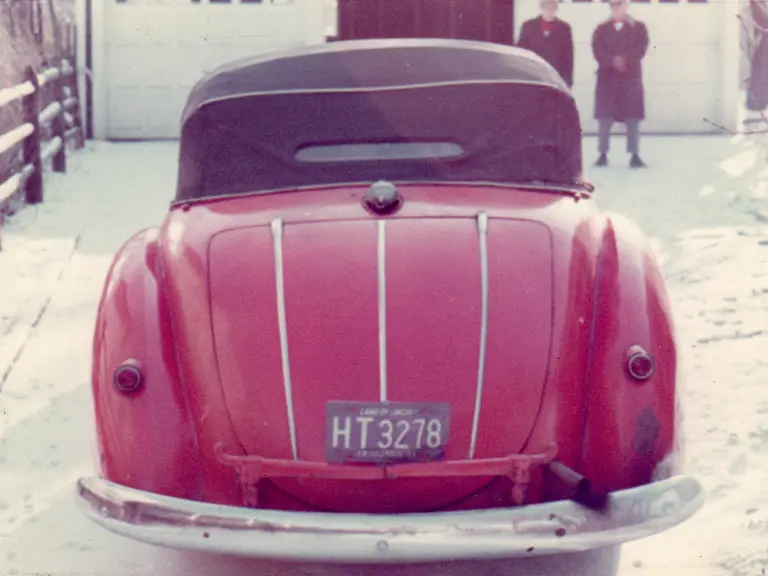 The Alfa Romeo wears its hood up to shield against the Chicago snow in the 1960s.
