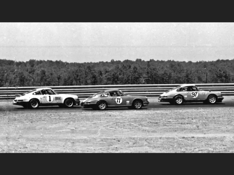 10 June 1973; IMSA Camel GT Championship Round 3, the 500 Miles of Pocono International Raceway; Hans Niederer and his #97 GTU-class 911 Rally dive past the #23 Chevrolet Corvette of GTO-class entrant, Allan Anderson.