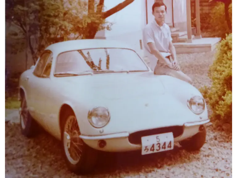 Hirotoshi Honda is pictured with the Lotus after its first rebuild, refinished in white.