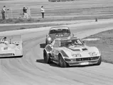 The RED Corvette (#5) leads a Mirage M6 (#2) and a Porsche 911 (#6) out of a corner at the 24 Hours of Daytona, 1973.