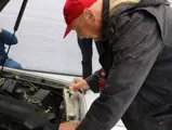 Niki Lauda is captured signing the engine bay of the 190 E 2.3-16 at the 2016 Australian Grand Prix.