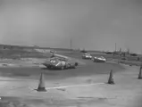 The #1 Chevrolet Corvette SS enters a turn behind the #8 Jaguar D-Type driven by Jack Ensley and Pat O’Connor. The #4 Chevrolet Corvette driven by Dick Thompson and Gaston Andrey exits the turn ahead of them and would go on to win its class at the 1957 12 Hours of Sebring.