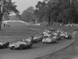 The Lotus (numbered 97) is pictured in a busy field at the Gold Cup Formula Two race at Oulton Park in 1956.